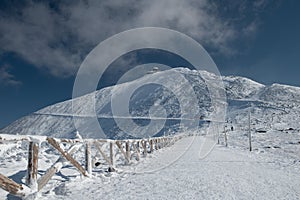 Fenced path to SnÃâºÃÂ¾ka mountain, the highest mountain in Czech republic in KrkonoÃÂ¡e range photo